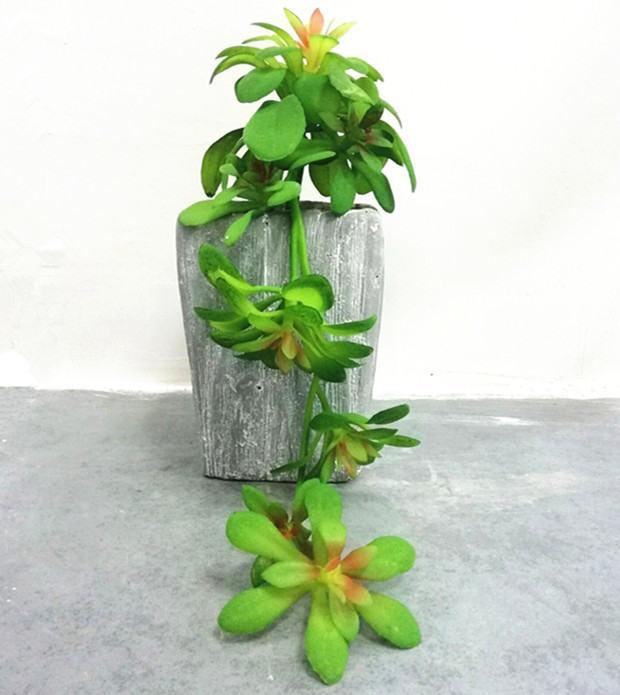 Assorted artificial succulent in concrete pot
