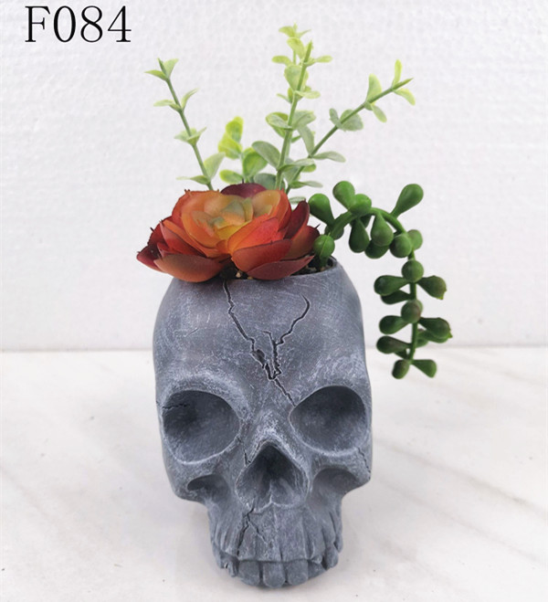 Fake succulent mixed in skull flower pot