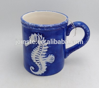 Blue ceramic coffee mug with sea horse painting