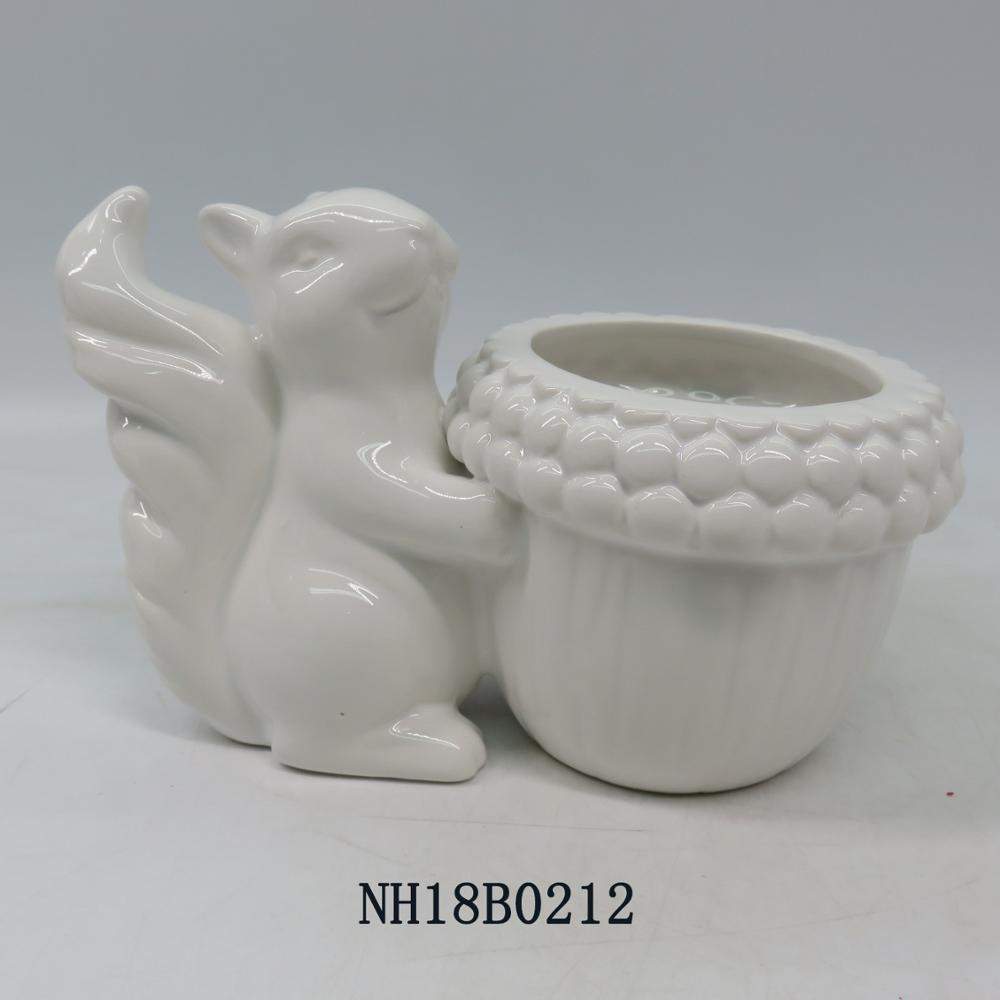 Squirrels and pine cones shaped decorative candlesticks and white ceramic candle holder